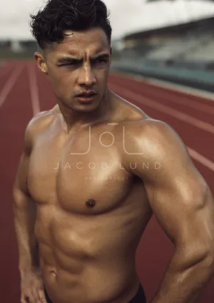 Bare chested athlete relaxing after a workout
